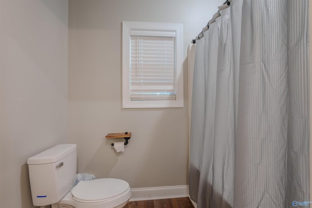 bathroom with wood-type flooring and toilet