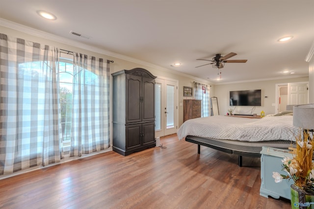 bedroom with crown molding, ceiling fan, and dark hardwood / wood-style flooring