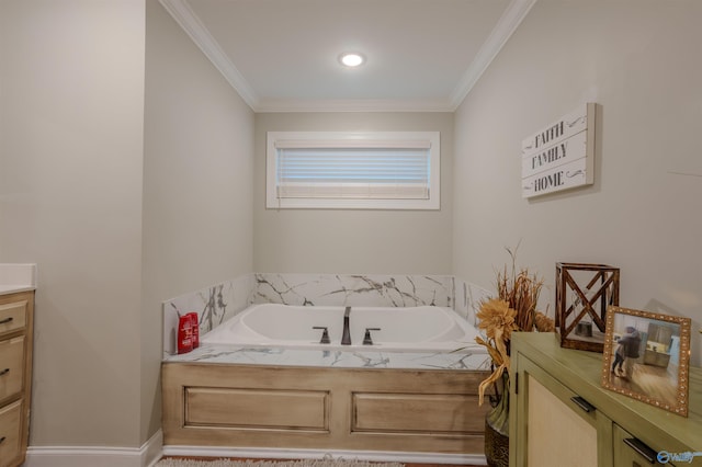 bathroom featuring ornamental molding, vanity, and a tub