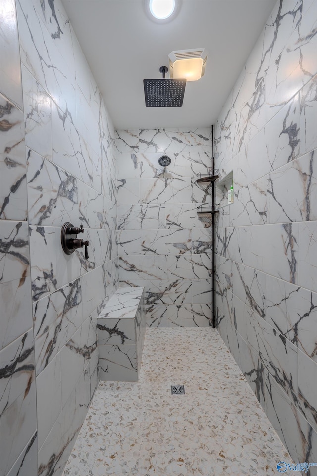 bathroom with tiled shower