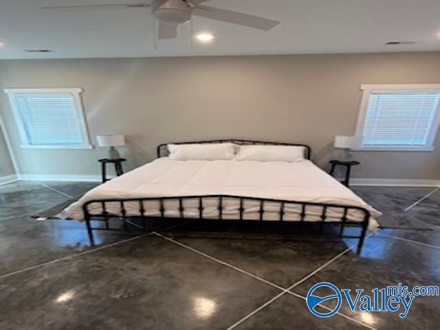 bedroom with multiple windows and ceiling fan