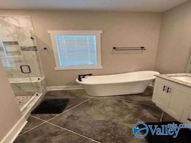 bathroom featuring vanity, independent shower and bath, and tile patterned flooring