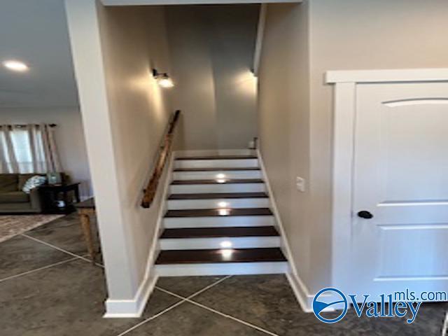 staircase featuring tile patterned flooring