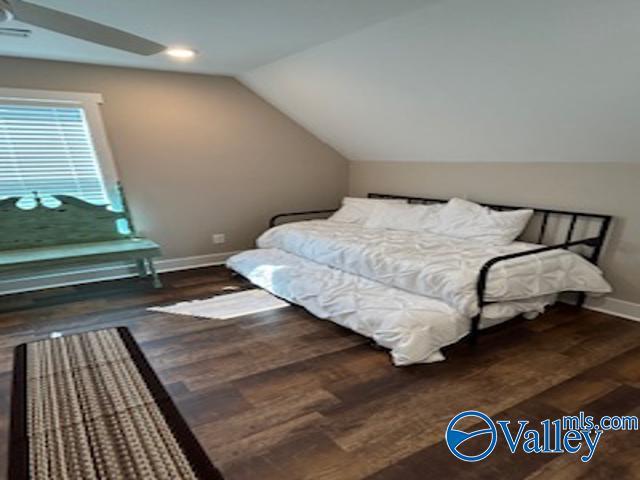 bedroom featuring lofted ceiling and dark wood-type flooring