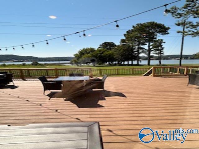 wooden terrace featuring a water view