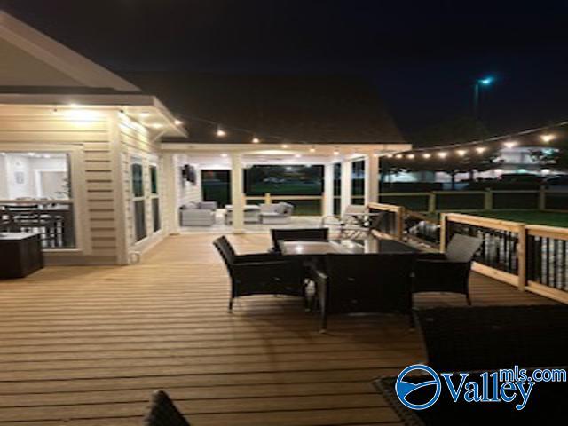 deck at twilight featuring outdoor lounge area