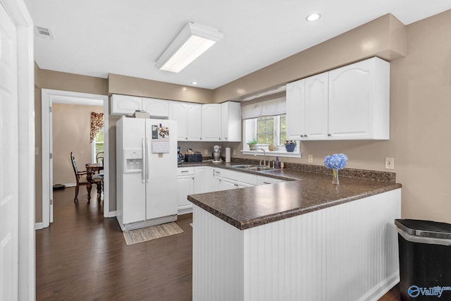 152 Old Vaughn Bridge Rd, Hartselle, AL 35640 - kitchen with white fridge with ice dispenser, a peninsula, dark countertops, a sink, and recessed lighting