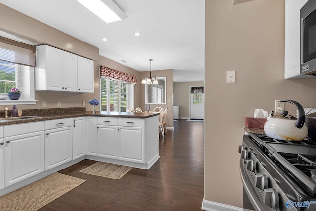 152 Old Vaughn Bridge Rd, Hartselle, AL 35640 - kitchen featuring a sink, dark wood-style floors, a peninsula, stainless steel appliances, and dark countertops