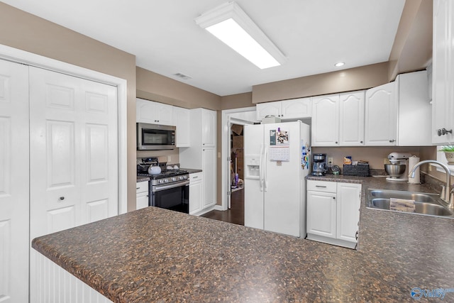 152 Old Vaughn Bridge Rd, Hartselle, AL 35640 - kitchen featuring appliances with stainless steel finishes, a sink, dark countertops, white cabinets, and recessed lighting