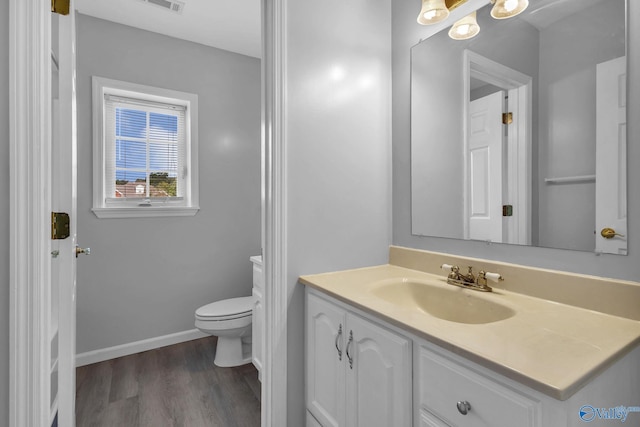 152 Old Vaughn Bridge Rd, Hartselle, AL 35640 - bathroom with vanity, toilet, wood finished floors, and baseboards