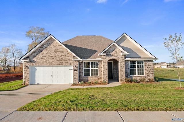 craftsman-style home featuring brick siding, a front yard, concrete driveway, and an attached garage