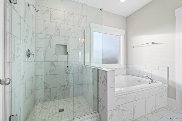 full bathroom with a bath and a shower stall