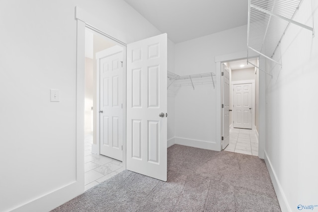 spacious closet featuring marble finish floor and carpet floors