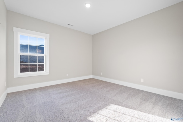 empty room with recessed lighting, visible vents, carpet, and baseboards