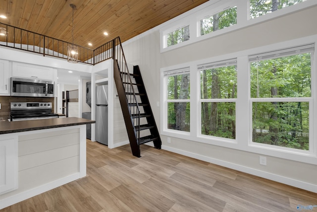 568 County Road 642, Mentone, AL 35984 - kitchen with appliances with stainless steel finishes, wood ceiling, dark countertops, white cabinets, and light wood-style flooring