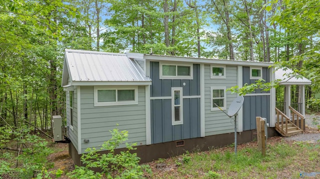 568 County Road 642, Mentone, AL 35984 - back of house featuring board and batten siding, crawl space, and an outbuilding