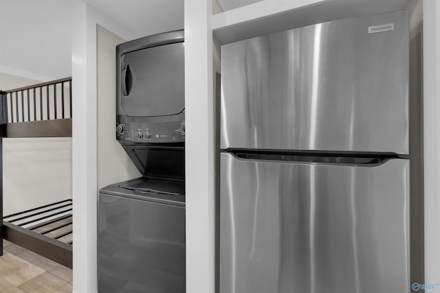 568 County Road 642, Mentone, AL 35984 - washroom with stacked washer / dryer and wood finished floors