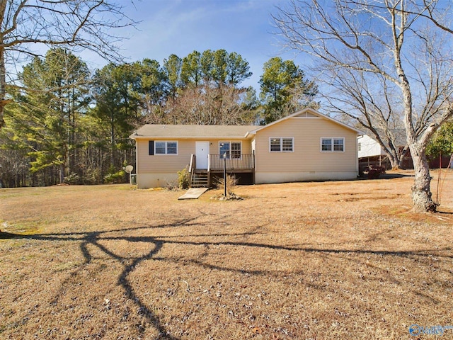 view of front of house featuring a wooden deck and a front yard