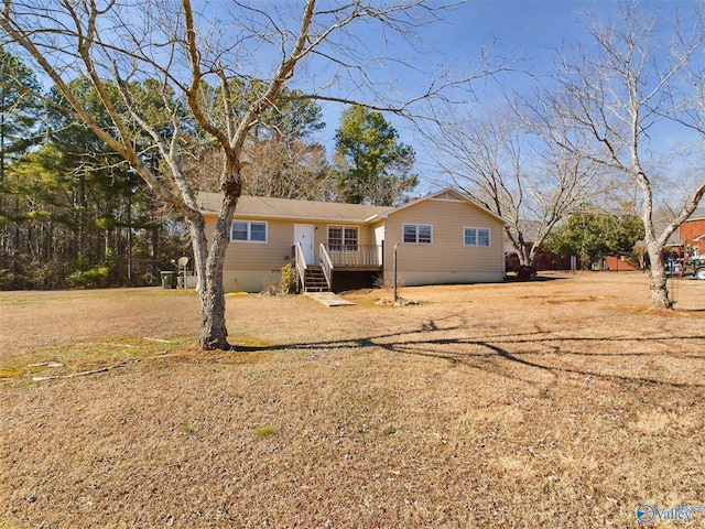 view of front facade with a deck and a front yard