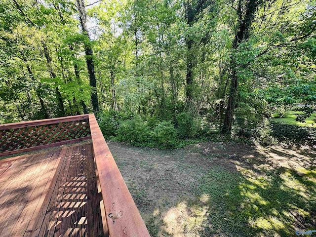exterior space featuring a deck and a view of trees