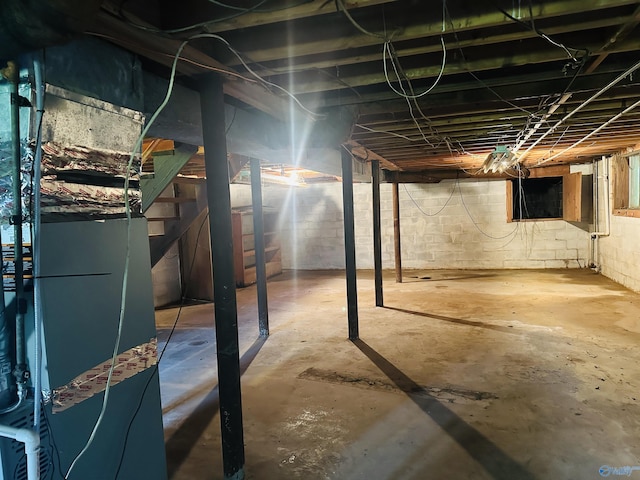 unfinished below grade area featuring heating unit