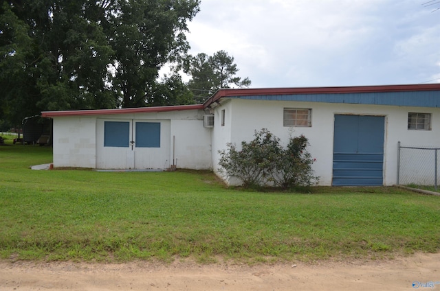 rear view of property featuring a yard