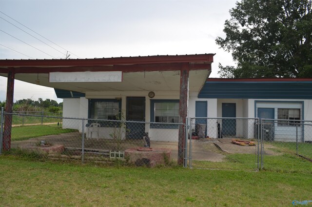 rear view of property featuring a lawn