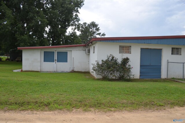 rear view of house featuring a yard