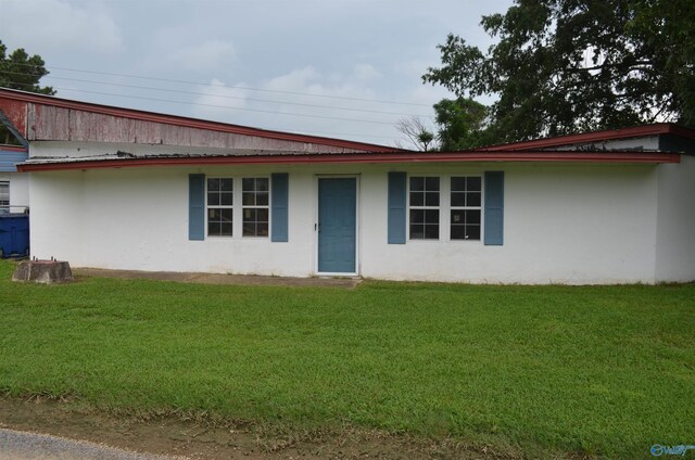 back of property featuring a lawn