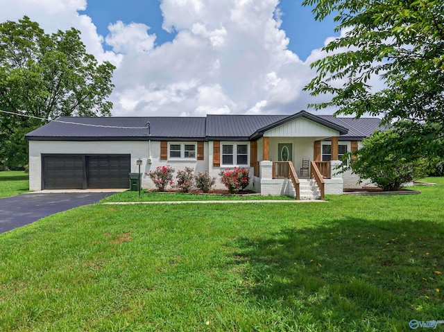 2605 Ready Section Rd, Toney, AL 35773 - single story home featuring an attached garage, a metal roof, driveway, and a front yard