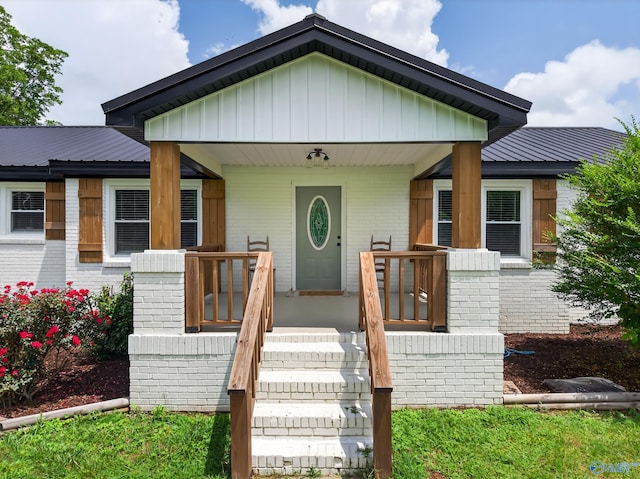 2605 Ready Section Rd, Toney, AL 35773 - bungalow-style home with brick siding, covered porch, board and batten siding, and a metal roof