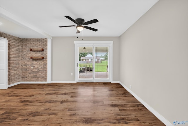 2605 Ready Section Rd, Toney, AL 35773 - spare room with brick wall, wood finished floors, and a ceiling fan
