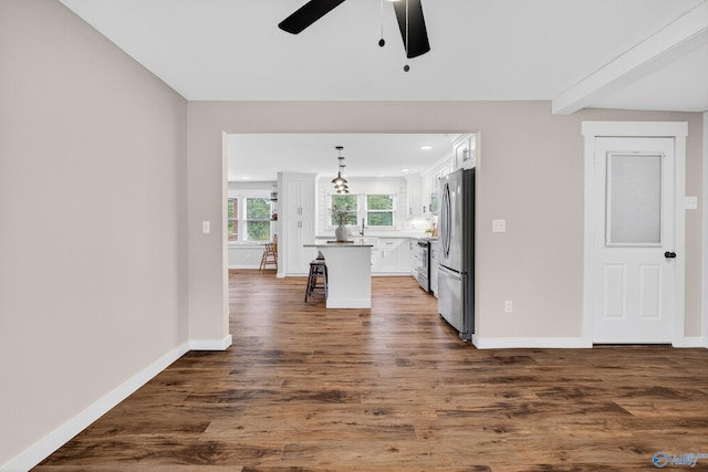 2605 Ready Section Rd, Toney, AL 35773 - kitchen with appliances with stainless steel finishes, ceiling fan, white cabinetry, a kitchen bar, and dark wood-type flooring