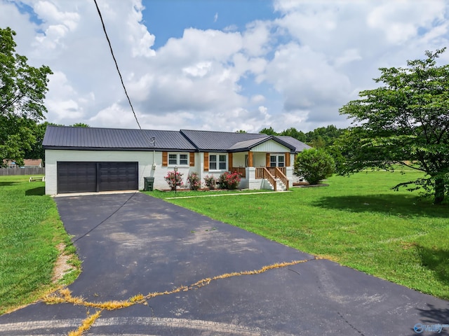 2605 Ready Section Rd, Toney, AL 35773 - view of front facade with asphalt driveway, a garage, a front yard, and a metal roof