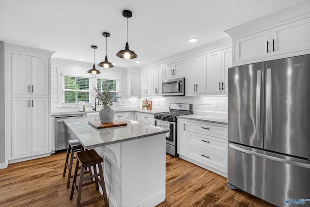 2605 Ready Section Rd, Toney, AL 35773 - kitchen with appliances with stainless steel finishes, white cabinetry, recessed lighting, and a kitchen breakfast bar