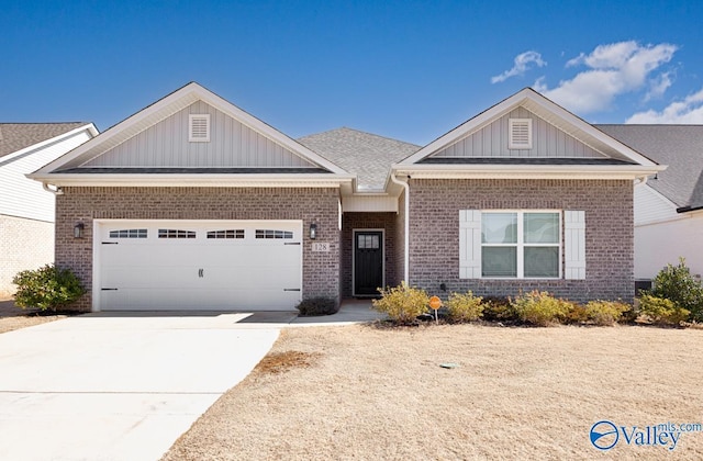 view of front of house with an attached garage, board and batten siding, concrete driveway, and brick siding