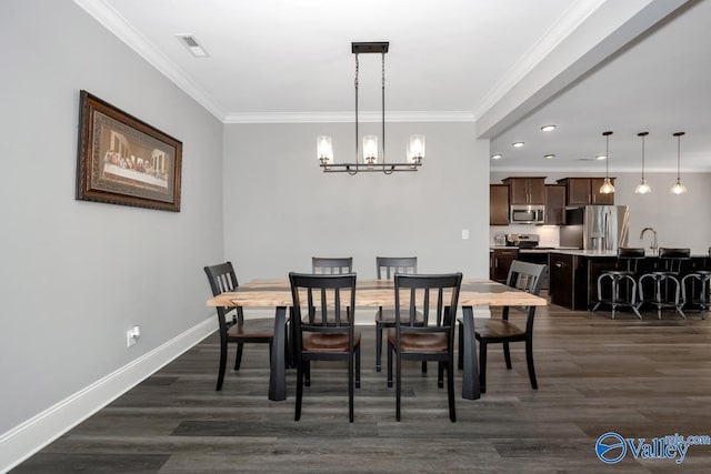 dining room with baseboards, dark wood-type flooring, visible vents, and crown molding