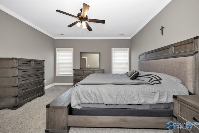 carpeted bedroom featuring ceiling fan, ornamental molding, visible vents, and baseboards