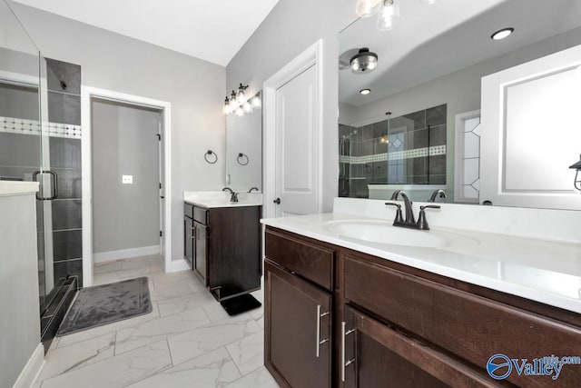 full bathroom featuring marble finish floor, a shower stall, and a sink