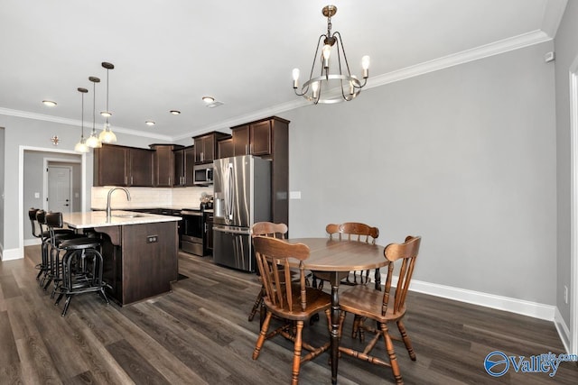 dining room with ornamental molding, dark wood-type flooring, and baseboards