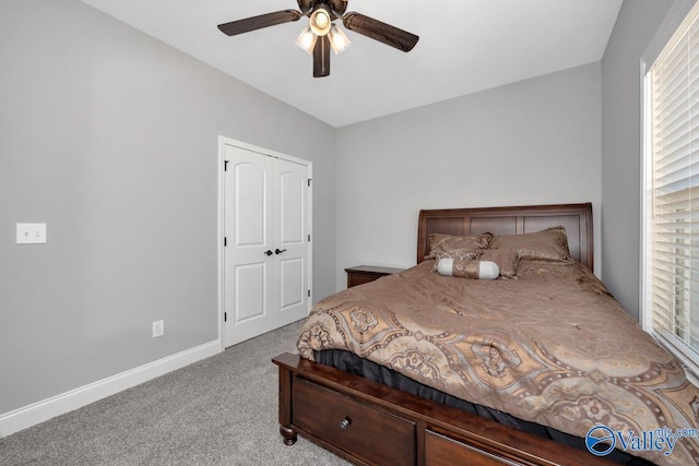 carpeted bedroom with a ceiling fan and baseboards