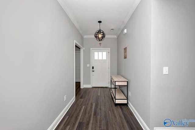 doorway to outside with dark wood-type flooring, crown molding, and baseboards