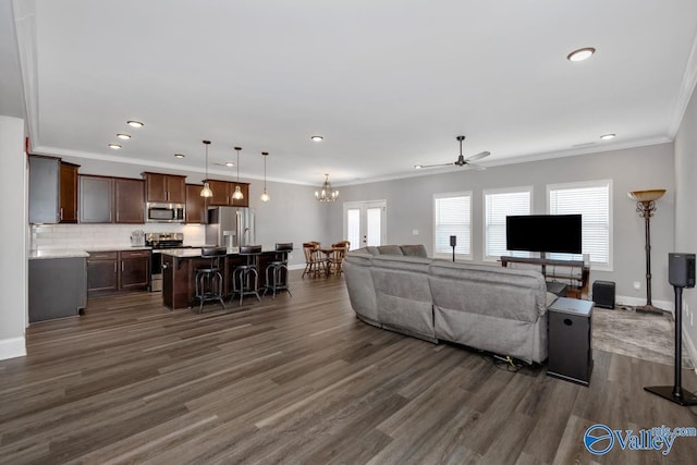 living area with crown molding, baseboards, dark wood-type flooring, and recessed lighting