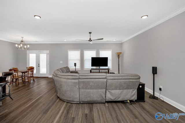 living room featuring dark wood-type flooring, ornamental molding, and baseboards