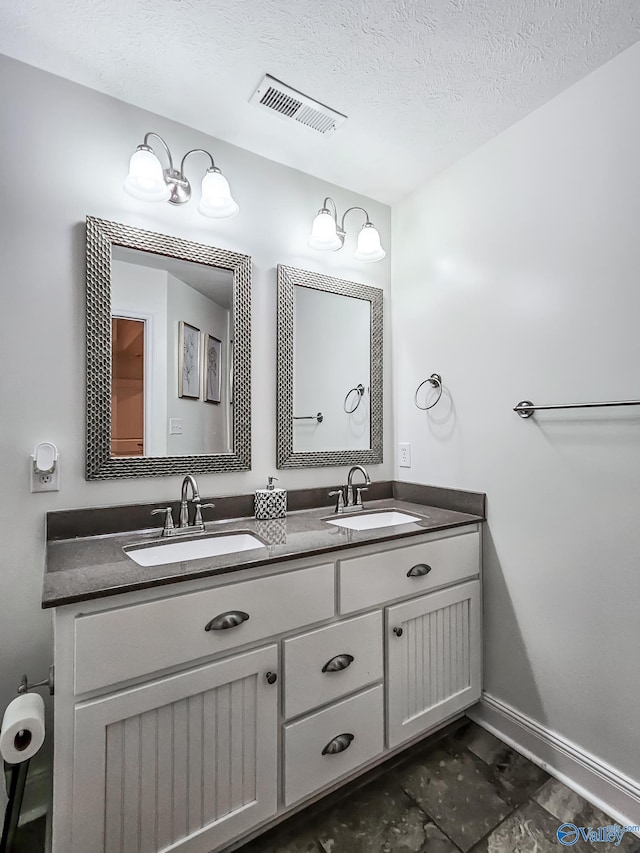 bathroom featuring vanity and a textured ceiling