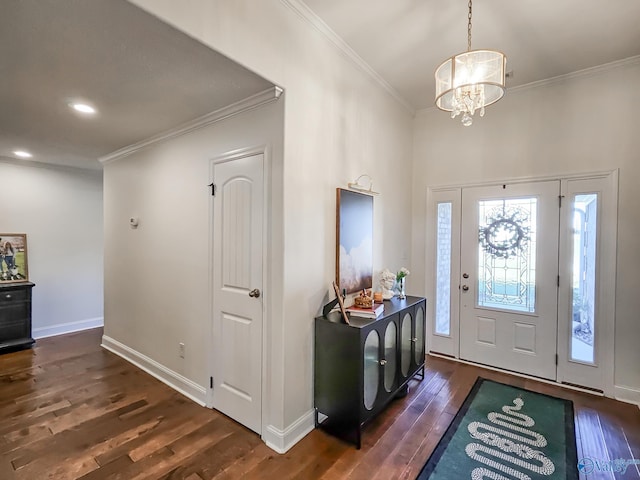 entrance foyer featuring ornamental molding, dark wood-type flooring, and a notable chandelier