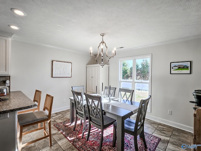 dining space featuring crown molding, a textured ceiling, and an inviting chandelier