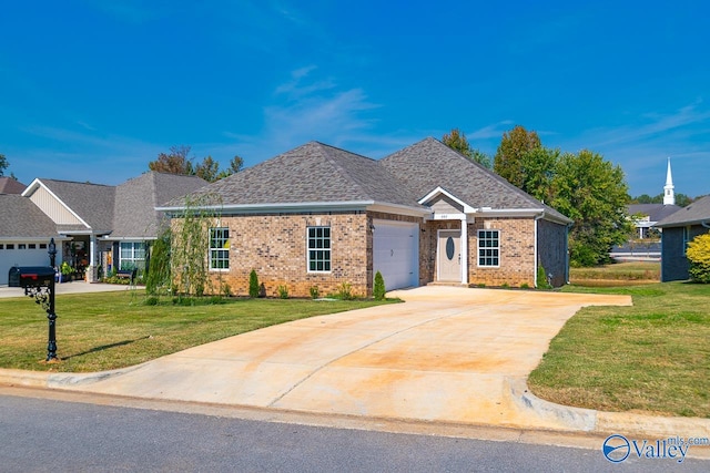 view of front of property with a garage and a front lawn