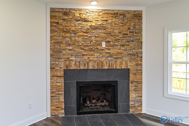 room details with a tile fireplace and hardwood / wood-style flooring