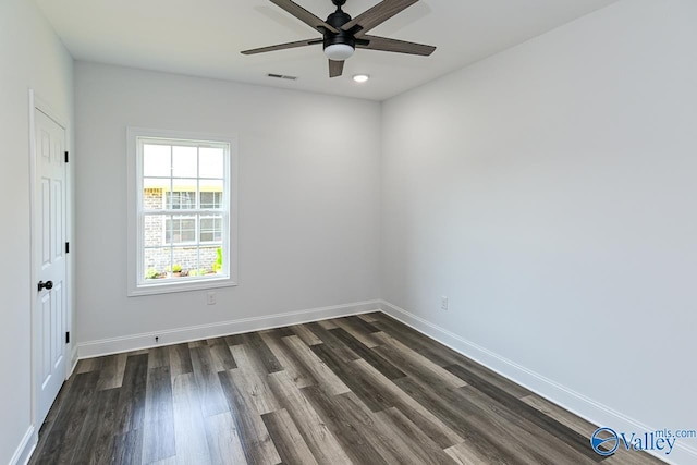 spare room featuring ceiling fan and dark hardwood / wood-style flooring